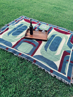 Decorative blanket with abstract patterns on grass