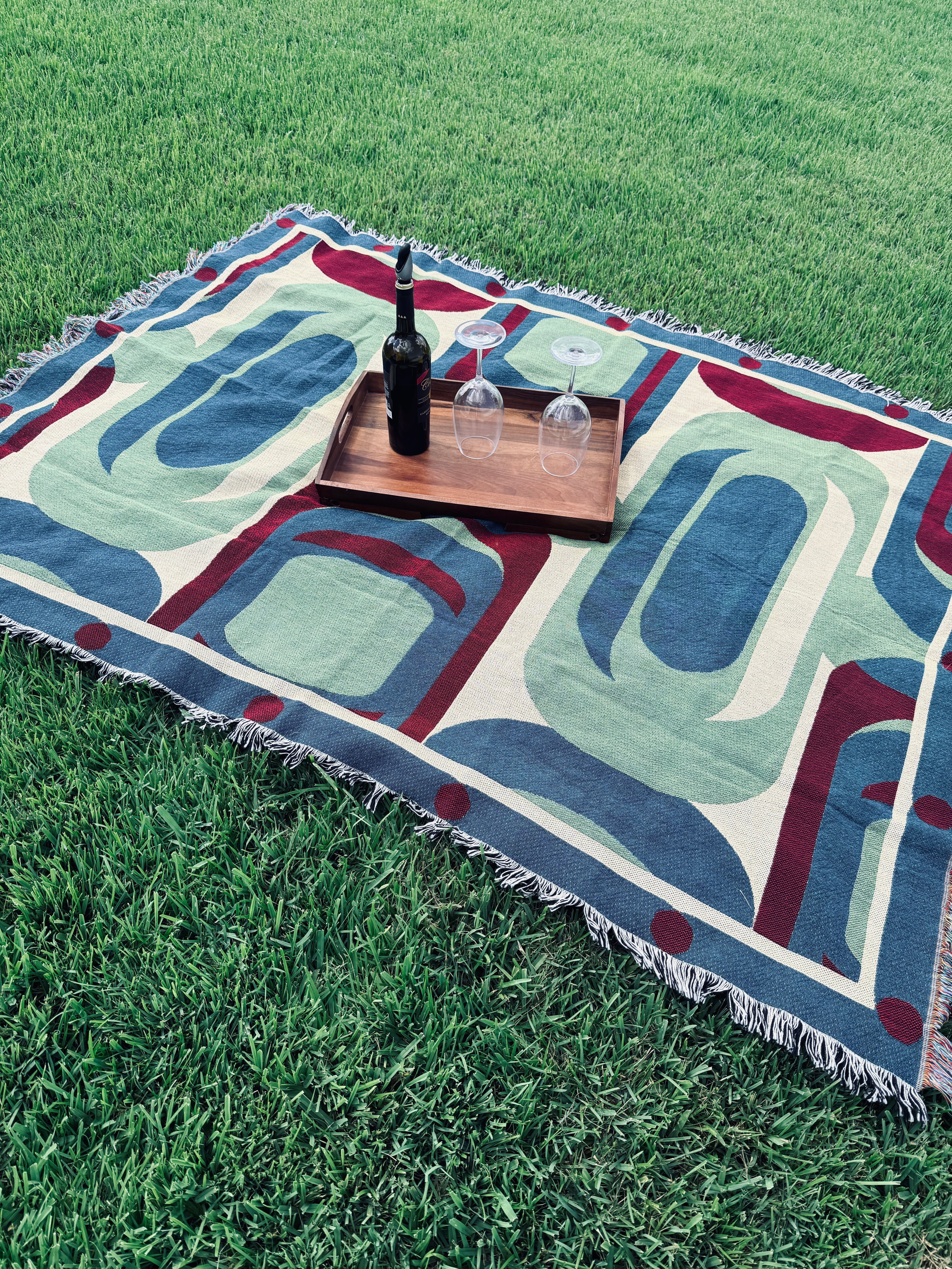 Decorative blanket with abstract patterns on grass