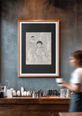 A framed minimalist art print featuring a beige and black line drawing of 2 women in a brown frame on a distressed gray wall.