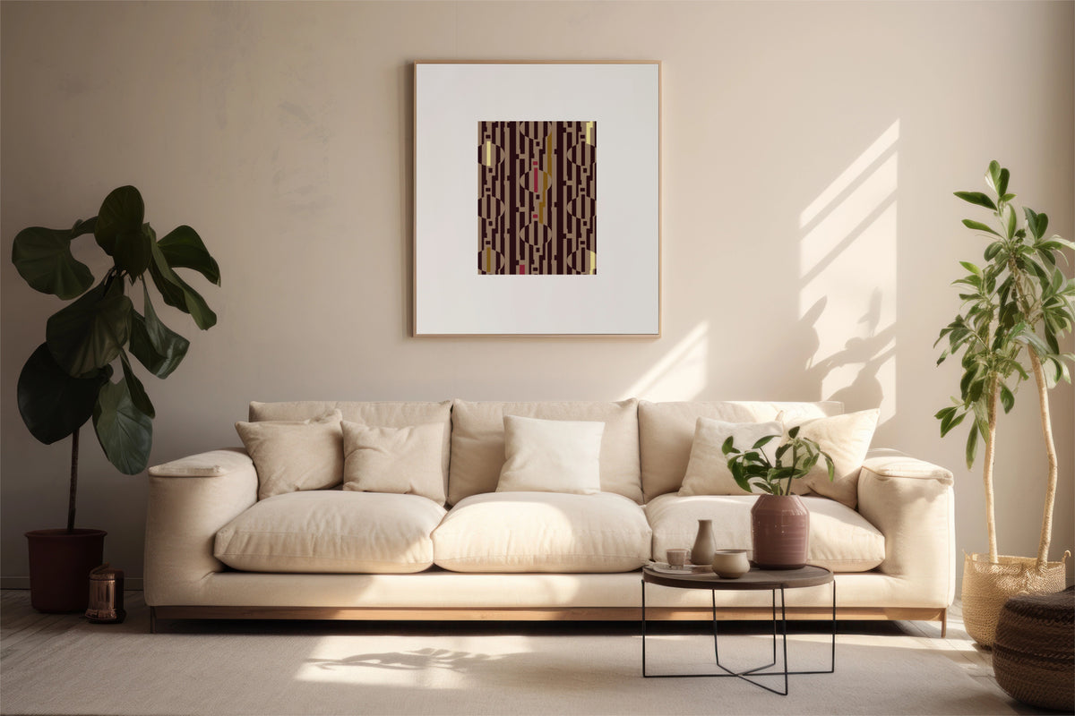 A framed abstract art print with vertical brown, pink, and yellow stripes hangs on a beige wall above a cream-colored sofa in a modern, sunlit living room with potted plants.