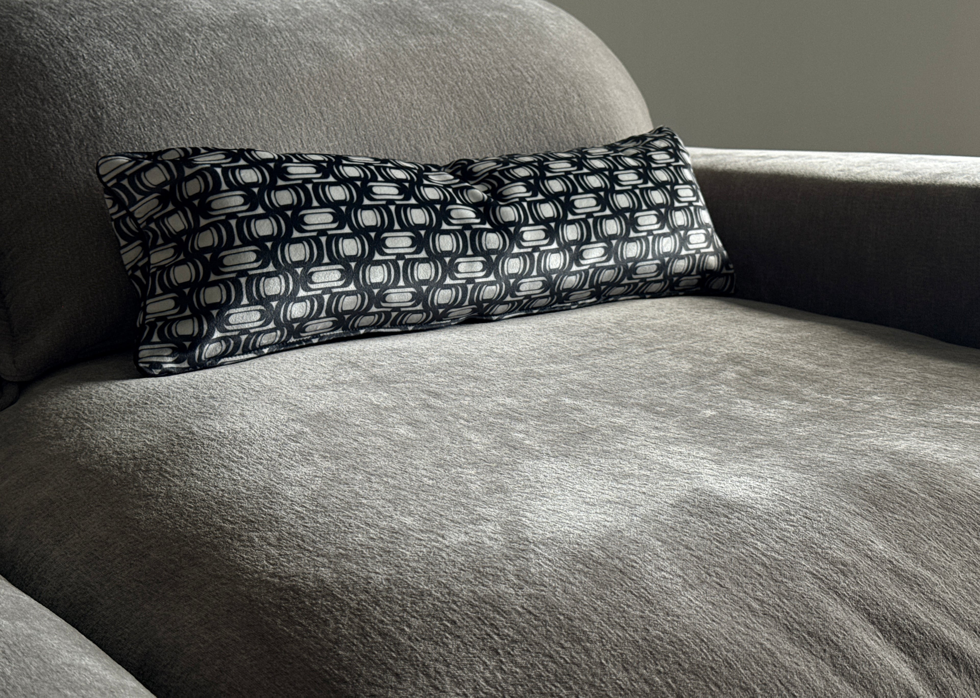 black and white lumbar throw pillow on gray couch