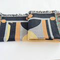 Patterned throw blanket with geometric designs on a white background