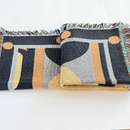 Patterned throw blanket with geometric designs on a white background