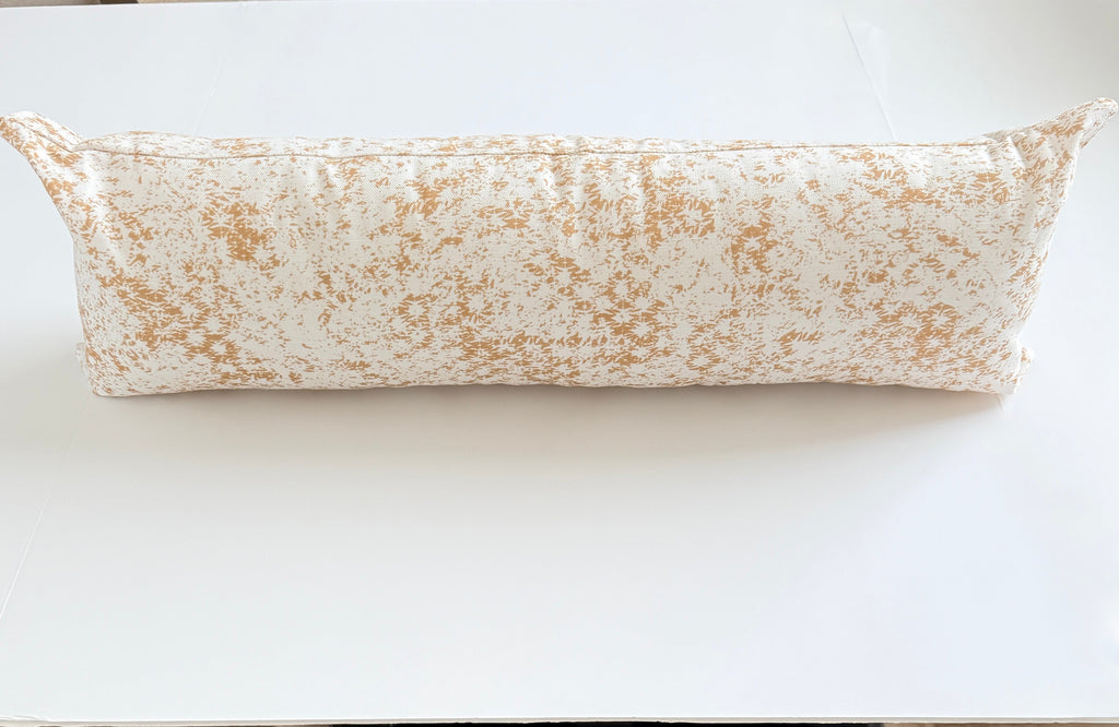 Long cylindrical pillow on a white surface