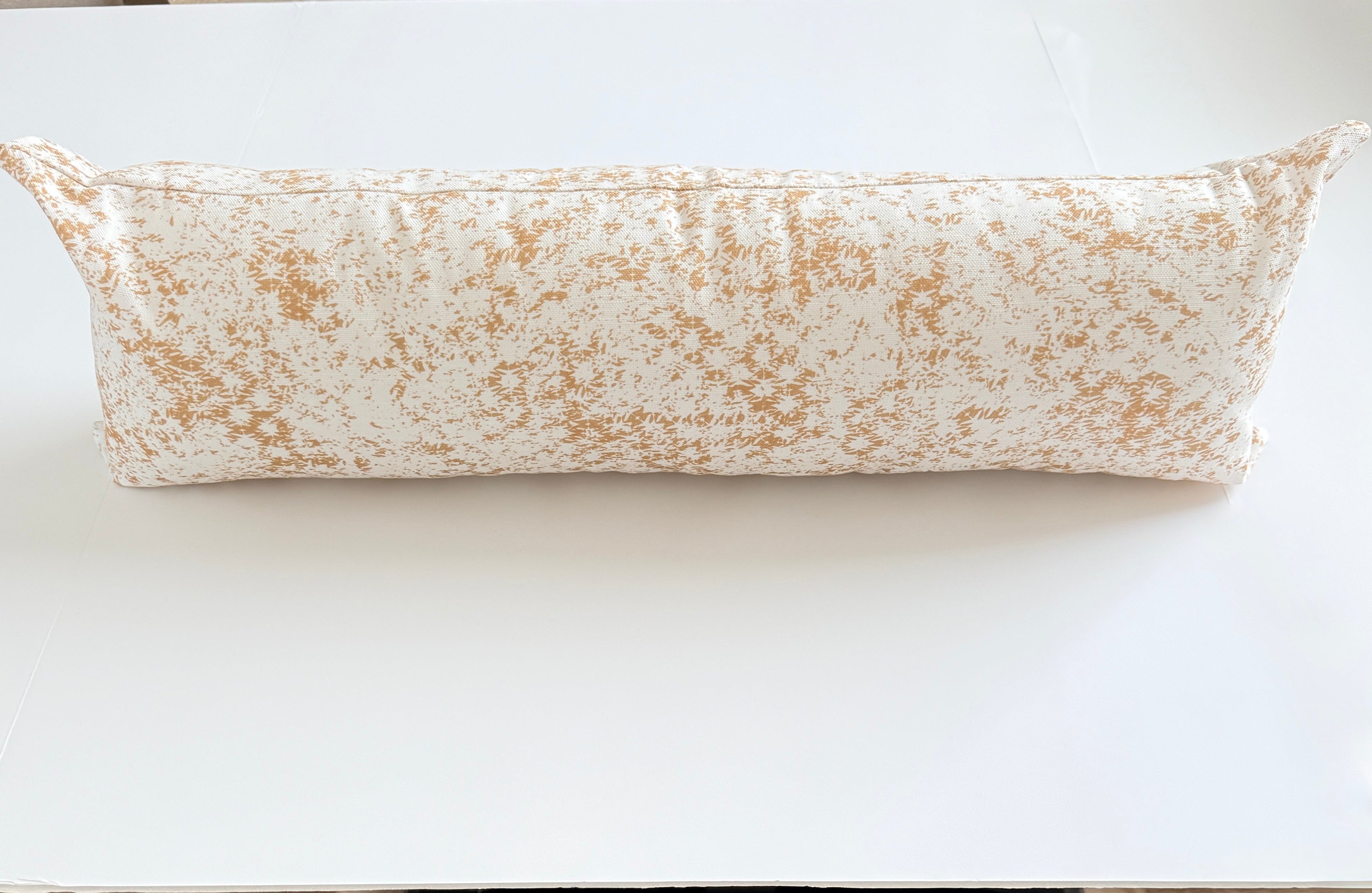 Long cylindrical pillow on a white surface
