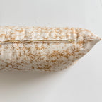 Decorative pillow with yellow and white pattern on a light background