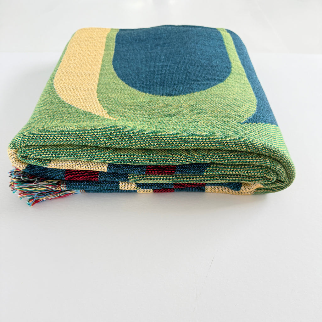 Folded blanket with geometric pattern on a white background