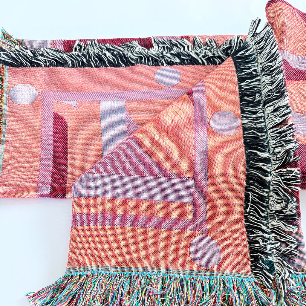 Colorful woven fabric with geometric patterns on a white background