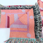 Colorful woven fabric with geometric patterns on a white background