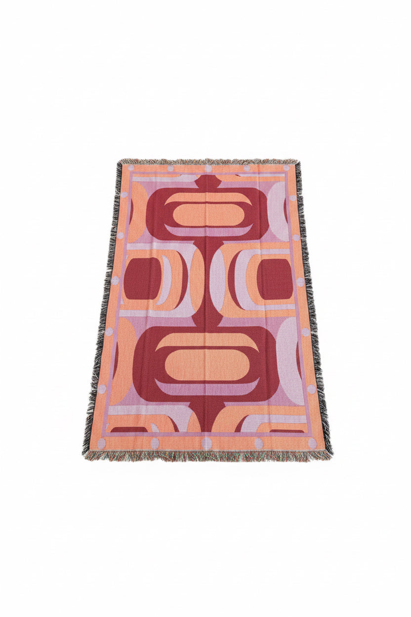 Patterned blanket with geometric design on a white surface