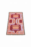 Patterned blanket with geometric design on a white surface
