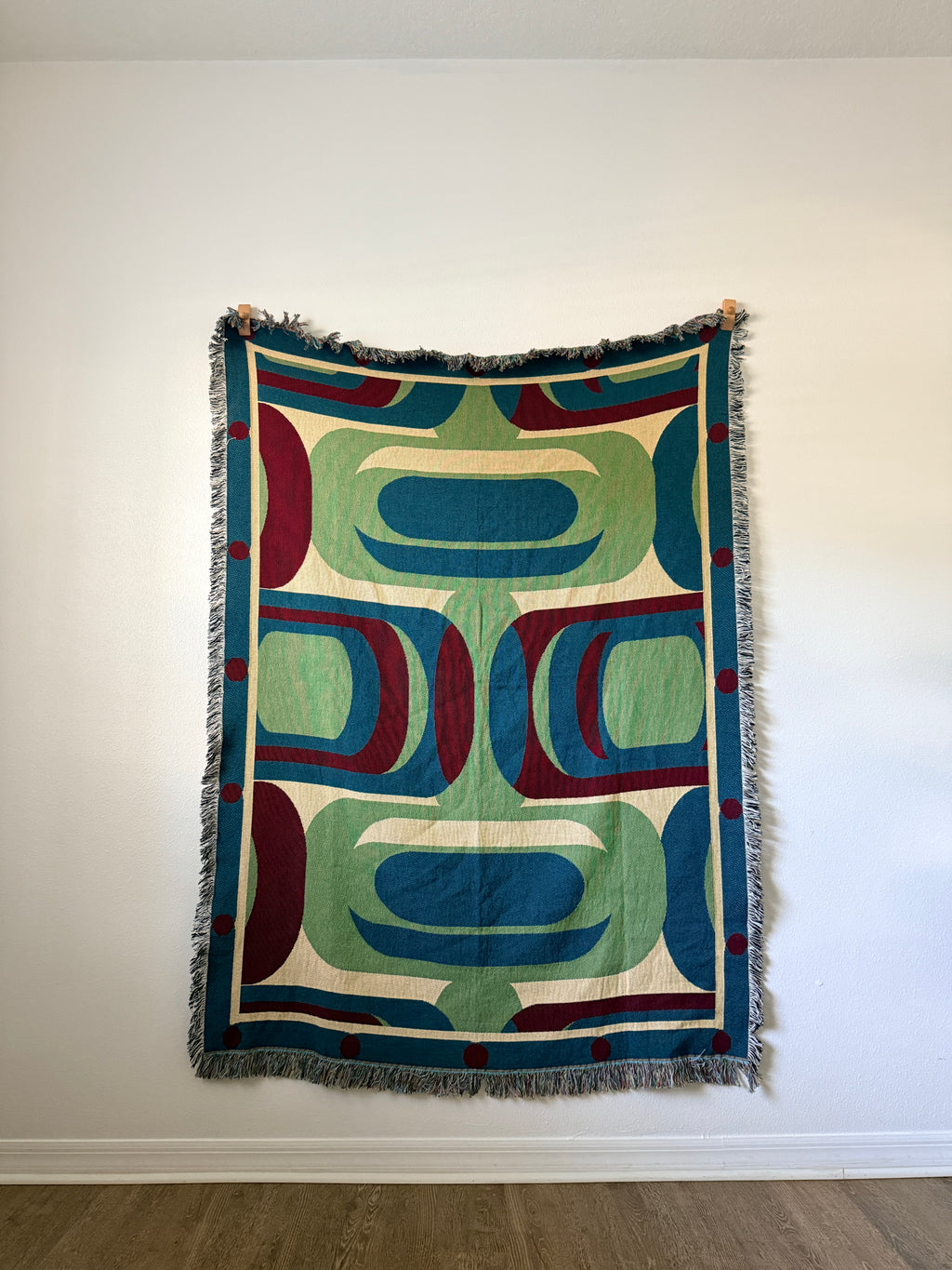 Decorative blanket with geometric pattern on a white wall