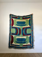 Decorative blanket with geometric pattern on a white wall
