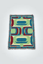 Colorful geometric-patterned blanket on a white background