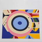 Colorful geometric matte art print on white surface.