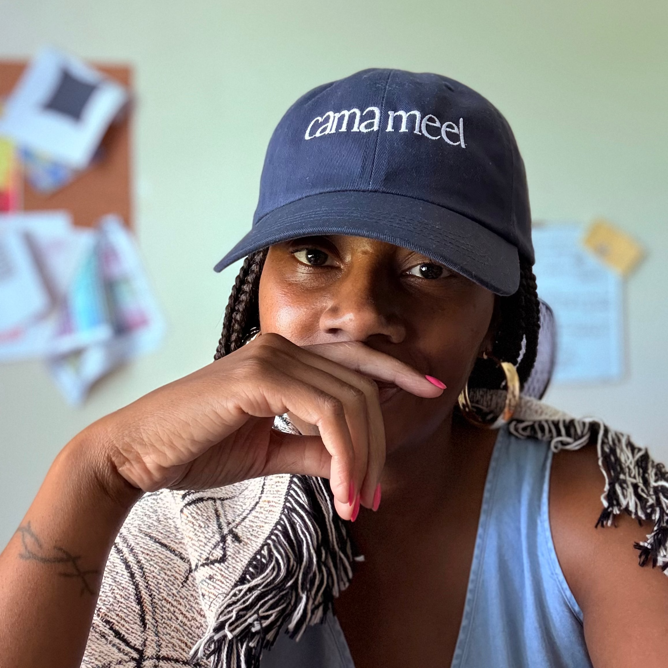image of artist sherri s. williams wearing cama meel logo hat