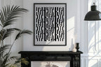 Framed black and white abstract pattern on a wall above a fireplace with decorative elements.